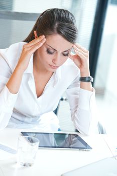 Overworking business woman suffering from headache 