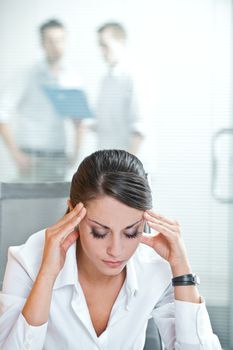 Overworking business woman suffering from headache 