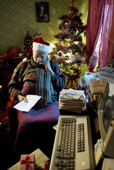 Pictures of Santa Claus sleeping in armchair at home