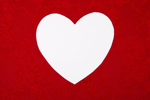 Big white heart on a red background, a Valentines Day theme.