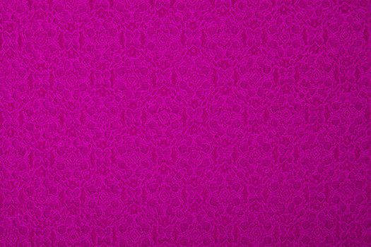 Pink/purple fabric with flowers, a textile background.