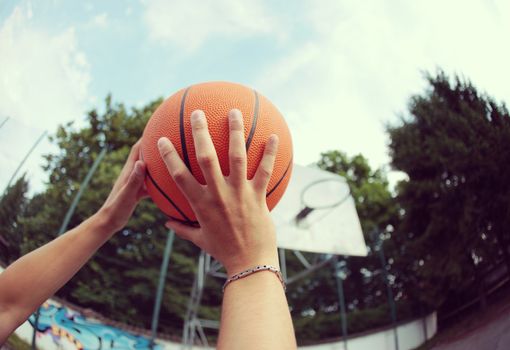 Hands close up of young basketball player at jump shot