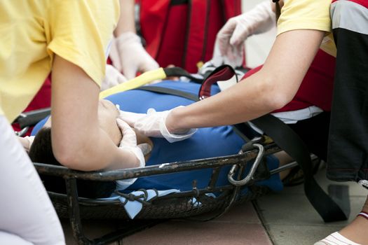 Paramedics putting a bandage on an injured hand