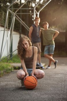 Teen Girl with basketball, her friends on the background