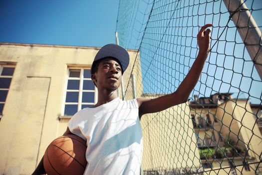 Portrait of african boy with basketball looking away