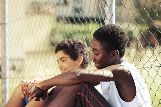 Two young African boy resting outdoors on a sunny day