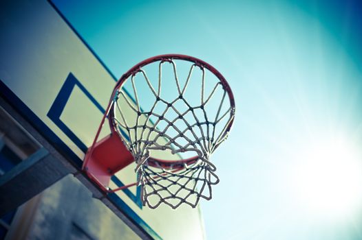 Basketball hoop against blue sky