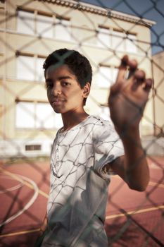 Portrait of young afro-american boy in a basketball court