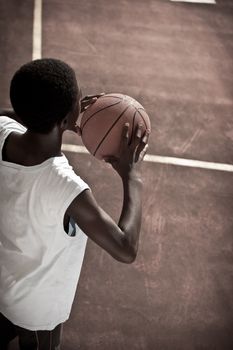 Afro-American boy playing basketball
