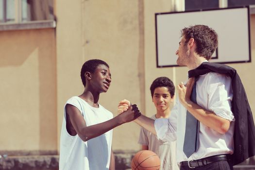 Multi-Ethnic Basketball players shaking hands after match