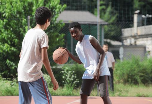 Two young African boy play basketball, 