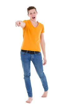 Young man, wearing a yellow T-shirt and slim jeans, standing on white background