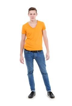 Young man, wearing a yellow T-shirt and slim jeans, standing on white background