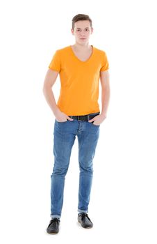 Young man, wearing a yellow T-shirt and slim jeans, standing on white background