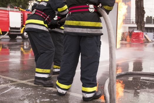 Firefighters fighting fire during training