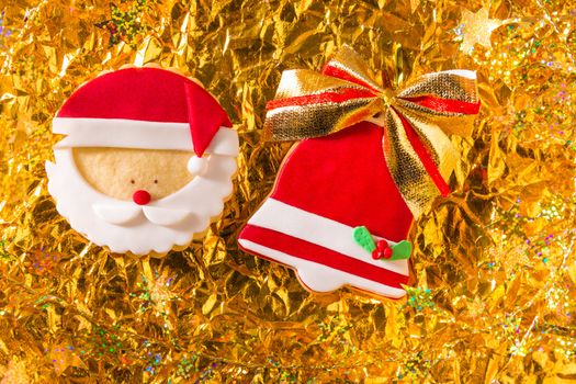 Christmas cookies Xmas red bell ribbon and Santa on golden background