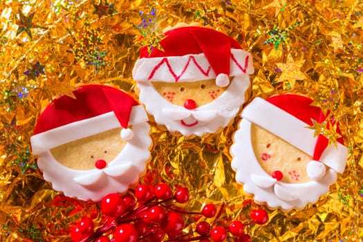 Christmas cookies with santa face on golden background