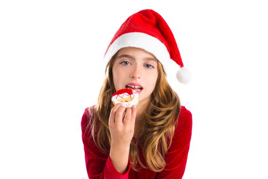 Christmas kid girl eating Xmas Santa cookie isolated on white background