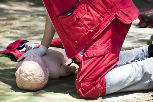 Paramedic demonstrates CPR on dummy