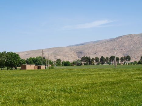 An adobe architecture in meadow field in Shiraz, Iran