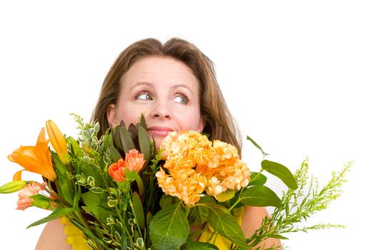 Happy woman looking up behind the flower  bouquet expressing her positive feelings genuinely