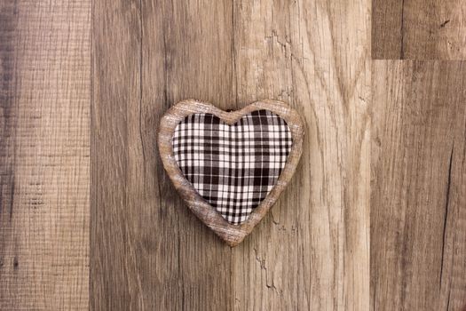 heart as symbol for christmas with wooden background 