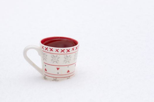 white cup on a background of a winter landscape, outdoors