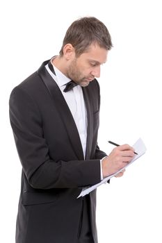 Handsome man in a bow tie and elegant suit standing writing notes, isolated on white