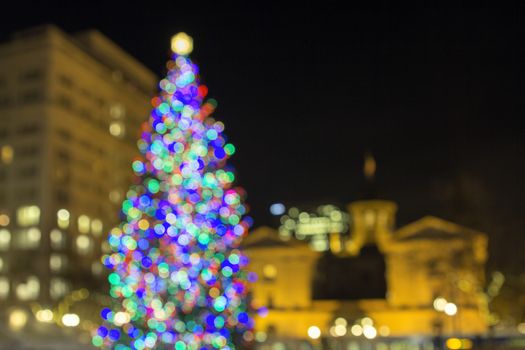 Christmas Holiday Tree at Pioneer Courthouse Square in Portland Oregon Downtown with Blur Defocused Bokeh Colorful Lights at Night