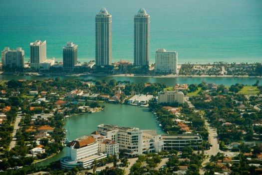 Aerial view of diverse apartment building and skyscrapers in Miami city with waterfront in background, Florida, U.S.A.