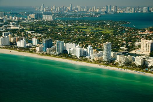 Aerial view of the coastline in Miami showing deep green and blue waters.