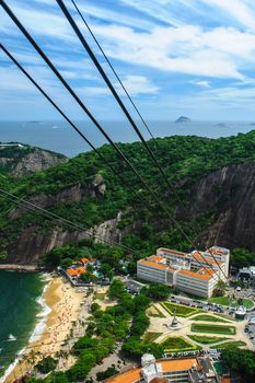 Aerial view of Urca neighborhood of Rio de Janeiro viewed from summit of Sugarloaf mountain with cable car lines in foreground, Brazil.