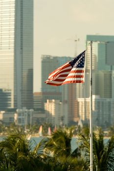 American flag fluttering with city in the background, Miami, Miami-Dade County, Florida, USA