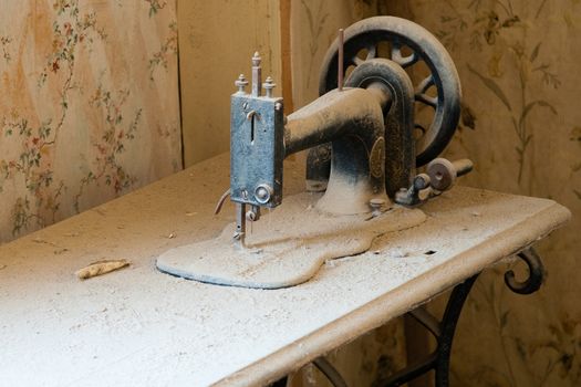 Antique sewing machine on dusty table in Bodie State Historic Park, California, U.S.A.