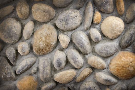 Wall of rocks and stones in cement background