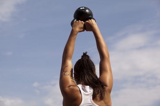 Woman doing kettlebell workout outside