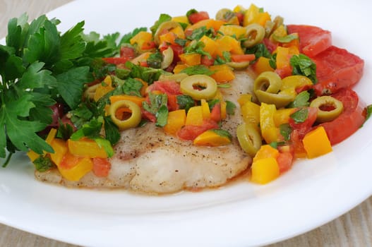 piece of juicy filet of fish with steamed vegetables