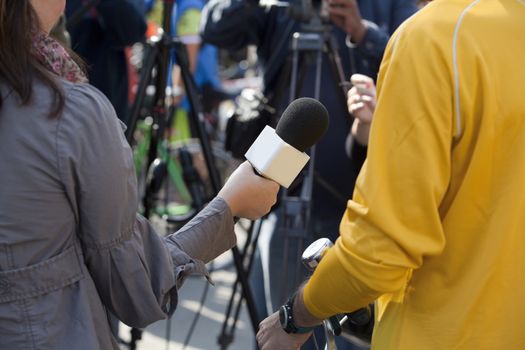 A journalist is making a interview with a microphone