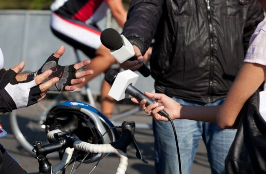 A journalist is making a interview with a microphone