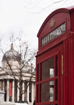 Traditional London symbol red public phone box and in the background the national gallery