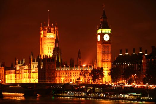 Big Ben and Palace of Westminster viewed over river Thames at night, London, England.
