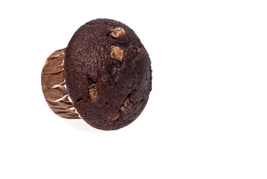 Close up of a fresh baked chocolate muffin against a white background