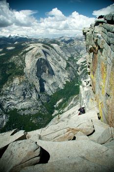 A climber going up the side of the Half Dome mountain in Yosemite National Park, California.