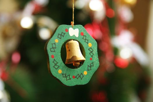 Close-up of a bell shaped Christmas ornament hanging from a string