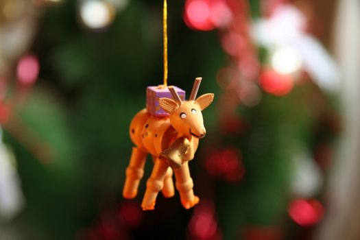 Close-up of a reindeer shaped Christmas ornament hanging from a string