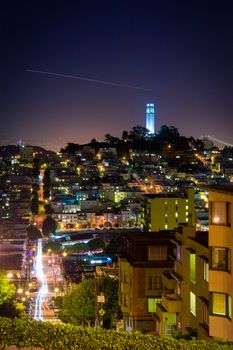 Coit Tower at night seen from Lombard Street of San Francisco, California.