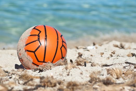Red ball in the sand.