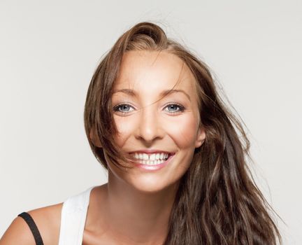 portrait of a young beautiful woman with brown hair smiling