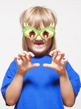 boy with funny glasses pretending to be a scary animal