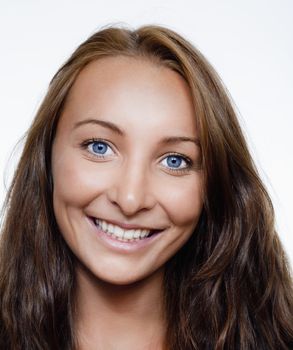 portrait of a young beautiful woman with brown hair and blue eyes smiling